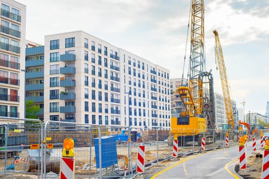 Excavator, cranes and construction equipment at construction site in downtown of Frankfurt , Germany