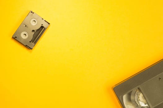 Video cassette on yellow background. mini cassette. copy space