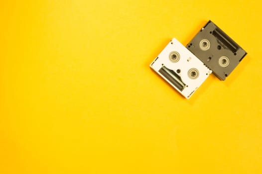 Digital video cassette on yellow background. mini cassette. copy space