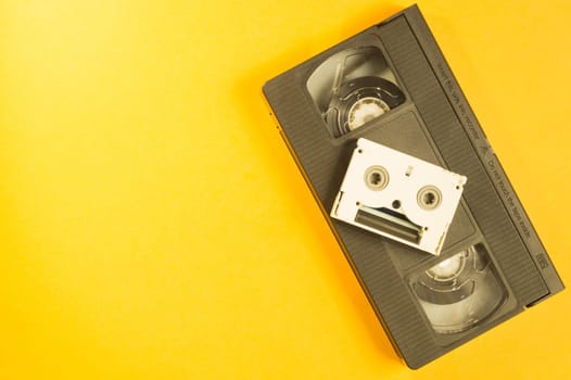 Video cassette on yellow background. mini cassette. copy space