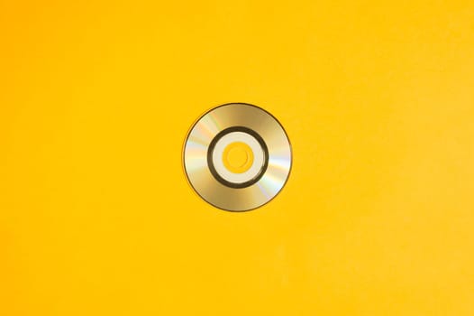 Mini compact disc on yellow background. copy space