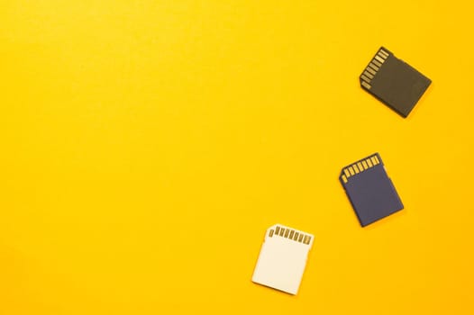 Memory card isolated on yellow background. Sd card and copy space