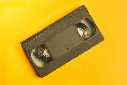 Video cassette isolated on yellow background. vhs with copy space