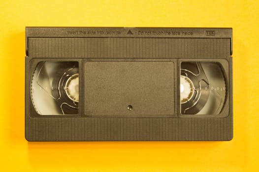 Video cassette isolated on yellow background. vhs with copy space