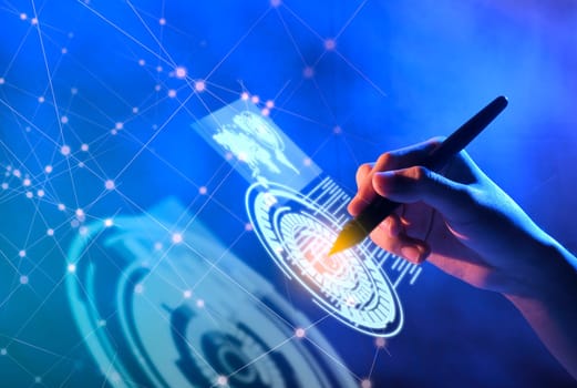 Business hand with markers touching a circle on virtual screen which display the interface of world maps, binary code and business network. Digital technology concept