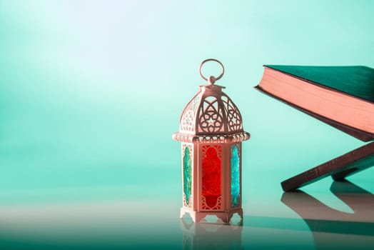 Arabic lamp with beautiful light and holy koran. Islamic concept image for ramadan