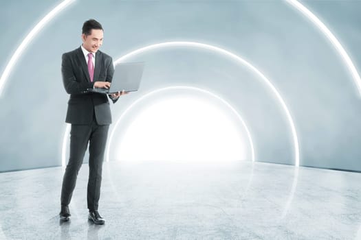 Side view of asian asian businessman holding laptop with his hand while walking on the office corridor. Future technology concept
