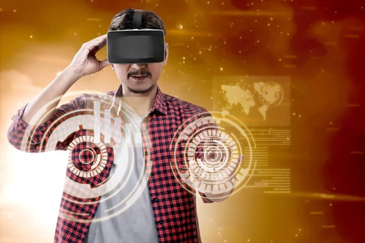 Asian man touching a circle on digital interface with virtual reality device display the world map and binary code. Augmented reality technology