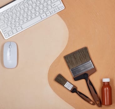 Painting accessories and computer keyboard lying on textural double background consisting of two beige shades. Top view with copy space, Concept of construction or design office. Internet shop
