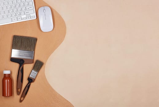 Painting accessories and computer keyboard lying on textural double background consisting of two beige shades. Top view with copy space, Concept of construction or design office. Internet shop
