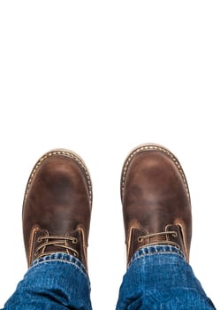 Men's brown boots and blue jeans. Isolated on white bacground