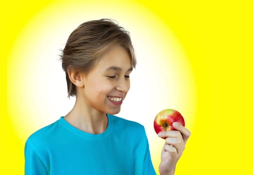 Portrait casual young man eating apple, against a white wall