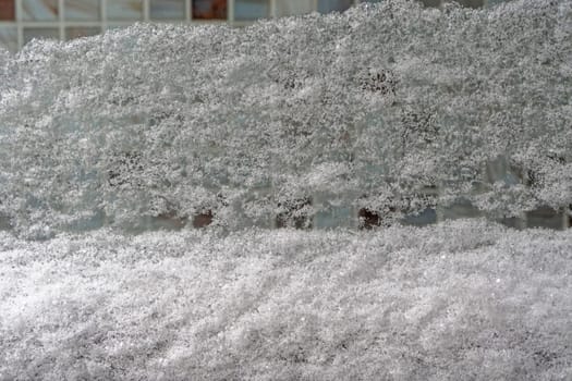 Big snow cover at window in winter