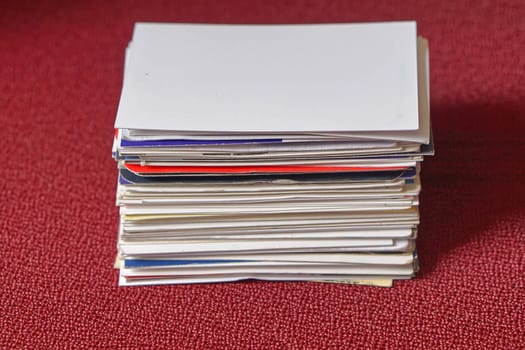 Big stack of business cards at red table