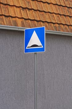 Speed bump road traffic sign at pole