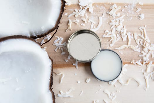 Coconuts with coconut cosmetic cream from a top down view.