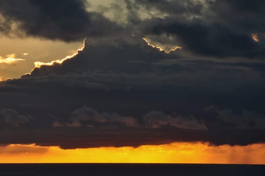 Cloudy sunset sky and sea horizon. Abstract nature background.