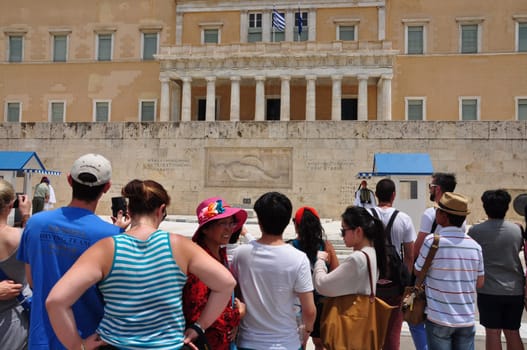 ATHENS, GREECE - JUNE 9, 2014: Crowd of people watch the inspection of the evzone soldiers guarding the tomb of the unknown soldier. Hellenic parliament, Athens Greece.