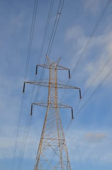 Transmission tower electricity pylon steel structure and power lines.