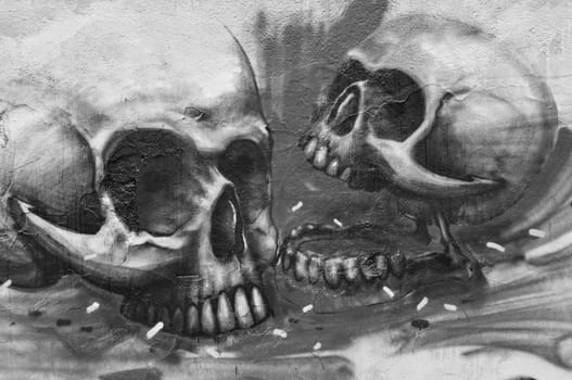 ATHENS, GREECE - DECEMBER 10, 2014: Two human skulls on textured wall abstract graffiti urban art. Black and white.