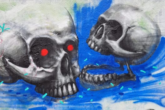 ATHENS, GREECE - DECEMBER 10, 2014: Two zombie skulls on textured wall abstract graffiti urban art.