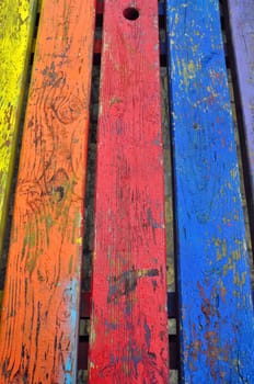 Wood background planks painted with vivid colors. Abstract texture.