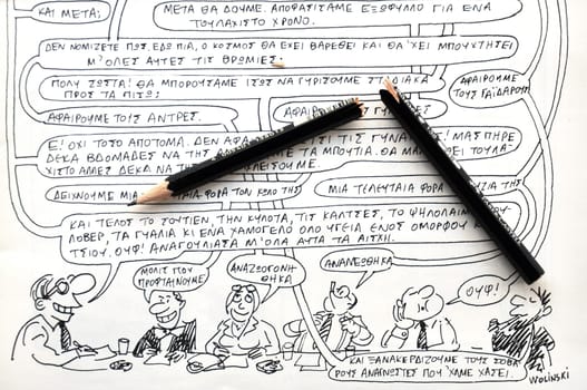ATHENS, GREECE - JANUARY 8, 2015: Broken pencil and comics by cartoonist and writer Georges Wolinski (1934 - 2015) victim of the terrorist attack at Charlie Hebdo satirical newspaper on January 7, 2015 in Paris, France.