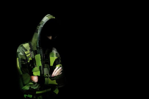 Unknown person in the hood. Danger in darkness. Concept