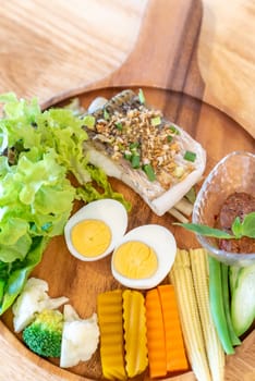 grilled sea bass with Galangal Nam phrik organic chili paste with variety organic vegetable and egg.  Thai traditional healthy food cuisine.