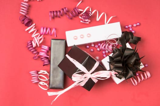 Set of gift boxes with bows, beads and ribbons on a colored background