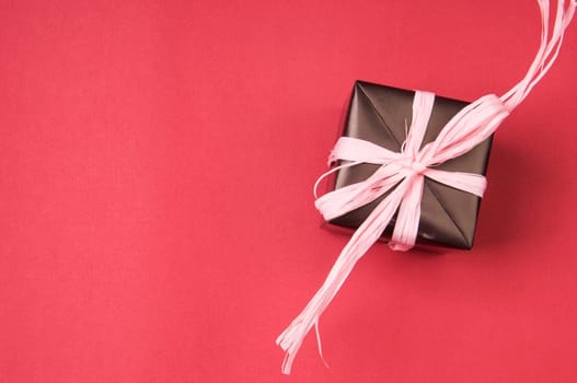 gift box with pink bows, and ribbons on a colored background