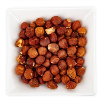 Tasty Hazelnuts in a bowl isolated on white background