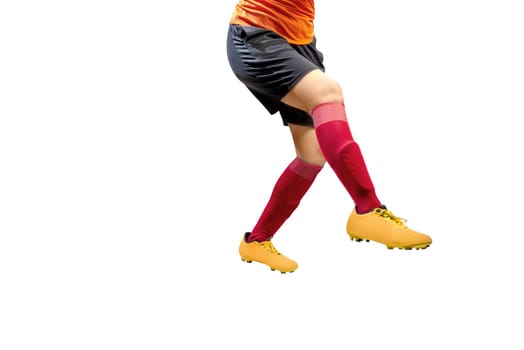 Football player woman in orange jersey kick the ball posing isolated over white background