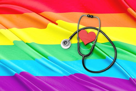 Stethoscope and heart shape with rainbow flag background. LGBT concept