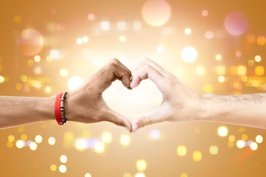 Couple of gay making a heart sign by hand with blurry lights background. LGBT concept