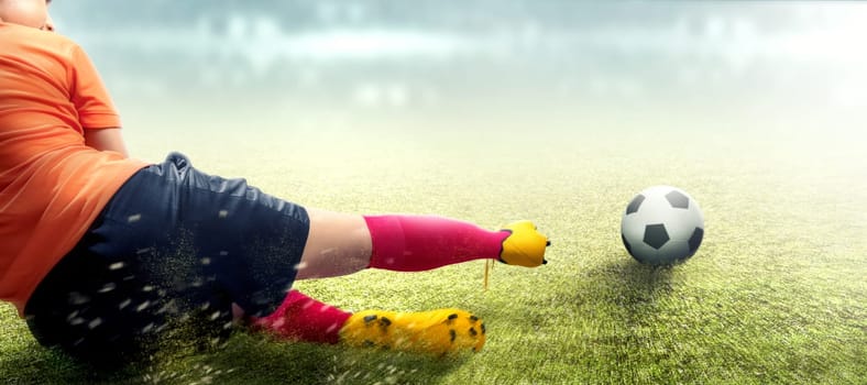 Asian football player woman in orange jersey sliding tackle the ball on the football field