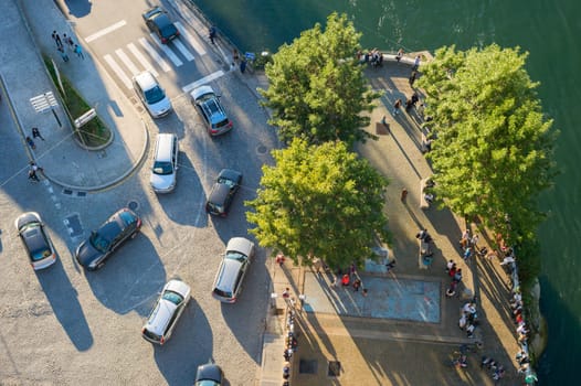 PORTO, PORTUGAL - NOVEMBER 13, 2016: Top view of cars traffic by Douro river paved waterfront and tourists at the viewpoint, Porto, Portugal