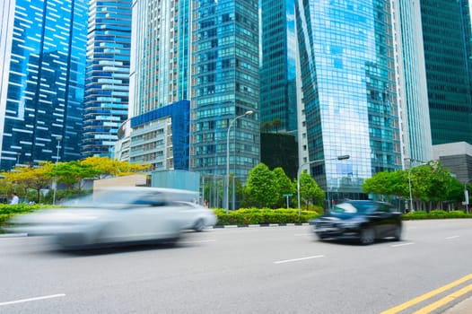 Rush hour in Singapore Downtown Core, car traffic on the road, modern architecture motion blur