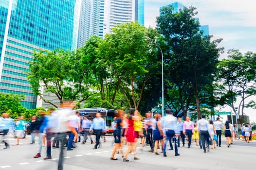 Cityscape with crowd of business people crossing road in Singapore downtown, metropolis skyline in background