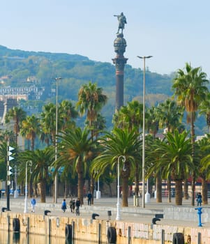 BARCELONA, SPAIN - NOVEMBER 03, 2016: People walking by Bacelona promenade. Columbus monument in the background.