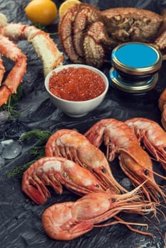 Set of seafood: red and black caviar, limb of hairy crab, limb of snow crab, far eastern kamchatka crab