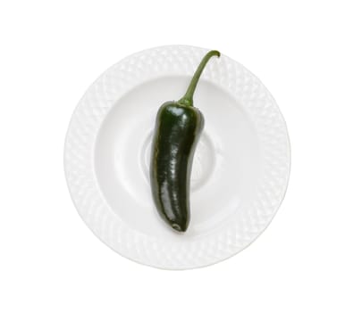 Single green jalapeno pepper on plate isolated on white background