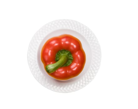 single red bell pepper on white plate isolated on white background