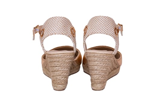 Golden shoes isolated. Closeup of a pair golden elegant female leather high-heeled shoes isolated on a white background. Womens shoe fashion 2019.