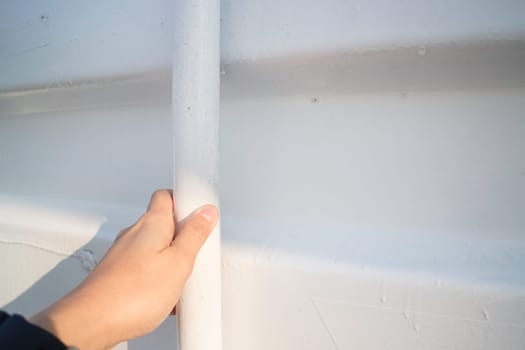 Hand on cargo container door, stock photo