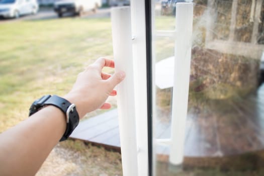 Hand on cargo container door, stock photo