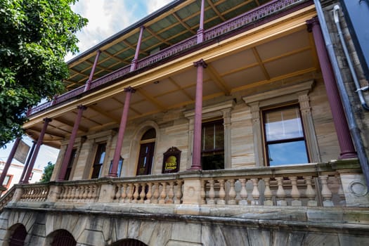 Facade of a heritage building with classical architecture elements such as Ionic columns and pilasters, using local supplied sandstone, in Grafton, New South Wales, Australia