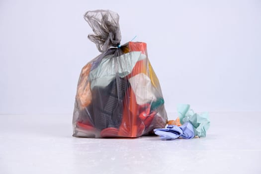 garbage bag with defferent content  in front of light background