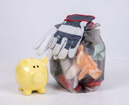 garbage bag with defferent content with yellow piggy bank