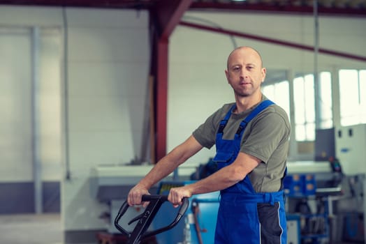 one worker in factory with hand lift